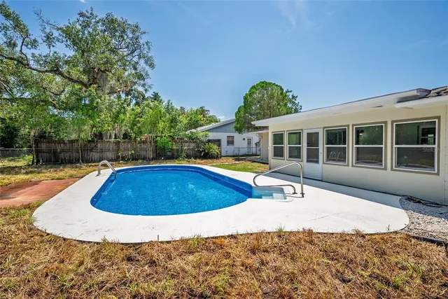 an aerial view of a house with a swimming pool