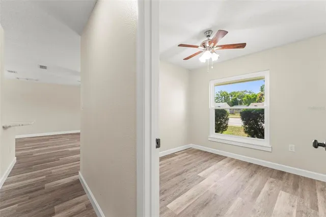 a kitchen with stainless steel appliances a refrigerator sink and white cabinets