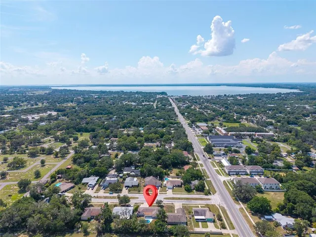 a kitchen with granite countertop a stove a sink and a microwave