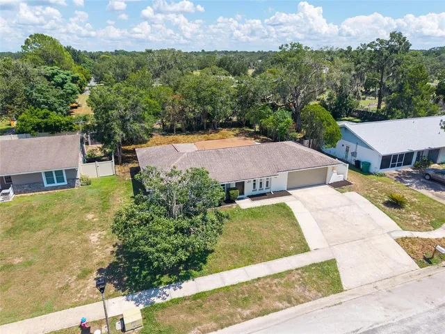 an aerial view of residential houses with outdoor space and river