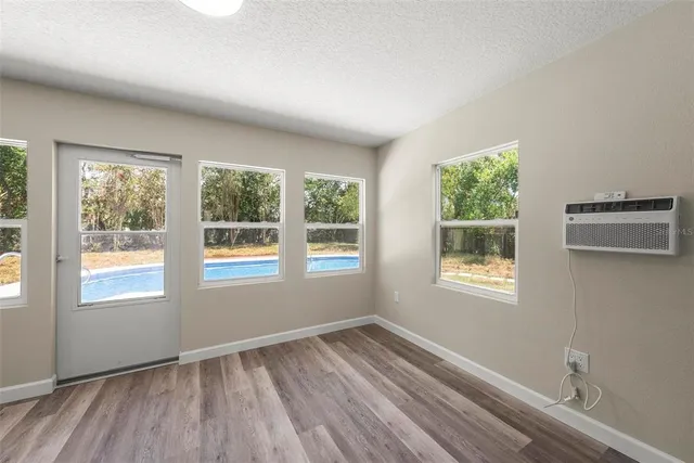 a view of an entryway with wooden floor and a window