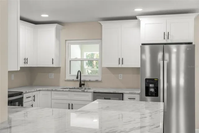 a front view of a house with yard and green space