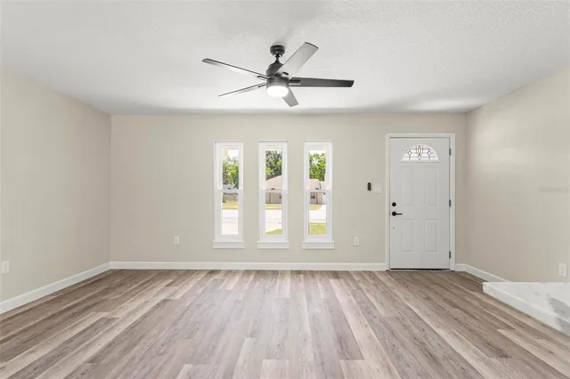 a kitchen with stainless steel appliances granite countertop a refrigerator sink stove and microwave