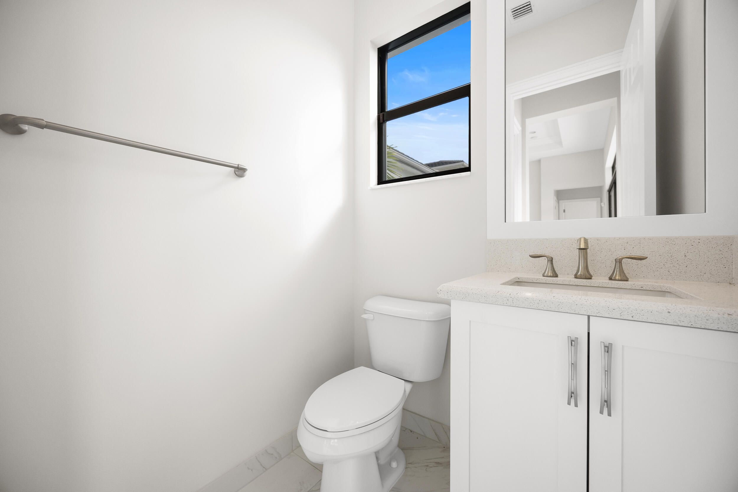 9168 Benedetta Place Boca Raton, FL 33496 - Photo 21 of 51 a bathroom with a granite countertop toilet sink and a mirror