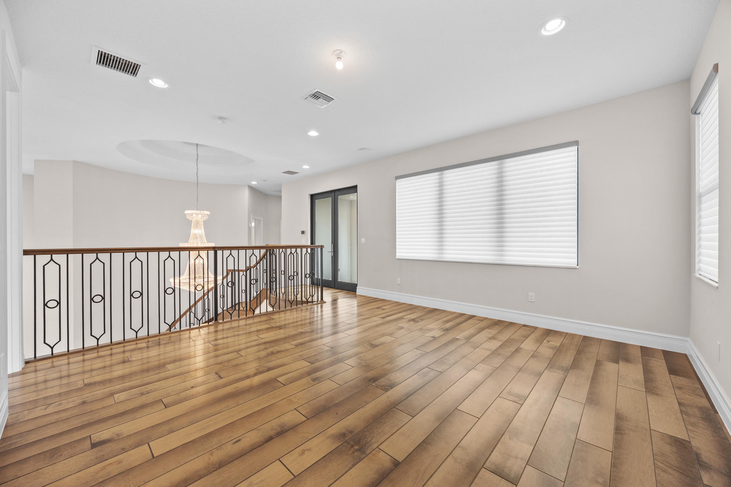 9168 Benedetta Place Boca Raton, FL 33496 - Photo 10 of 51 a view of an empty room with wooden floor and a window