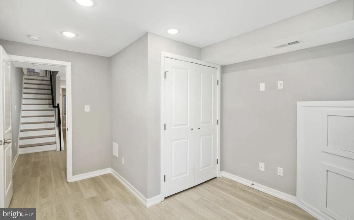 2426 Jasper Street, Unit A Philadelphia, PA 19125 - Photo 17 of 19 wooden floor in an empty room with a window