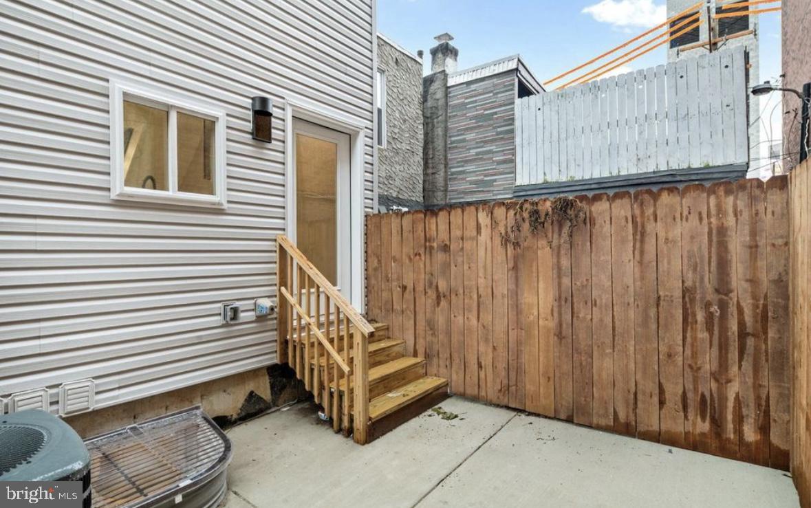 2426 Jasper Street, Unit A Philadelphia, PA 19125 - Photo 7 of 19 a back view of a house with a wooden fence