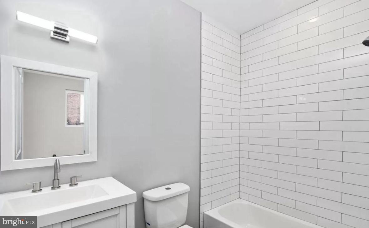 2426 Jasper Street, Unit A Philadelphia, PA 19125 - Photo 10 of 19 a bathroom with a sink a toilet and shower