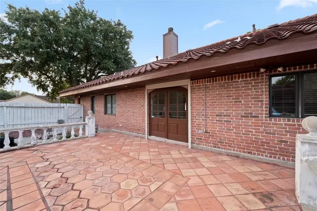 a backyard of a house with barbeque oven
