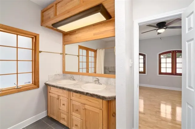 a bathroom with a sink a vanity and a large mirror