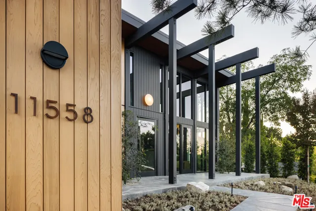 a view of a porch with a table and chairs