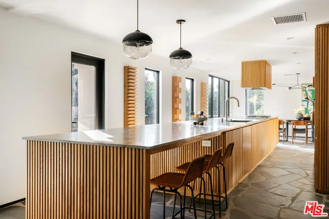 a kitchen with stainless steel appliances granite countertop a sink a stove and a refrigerator