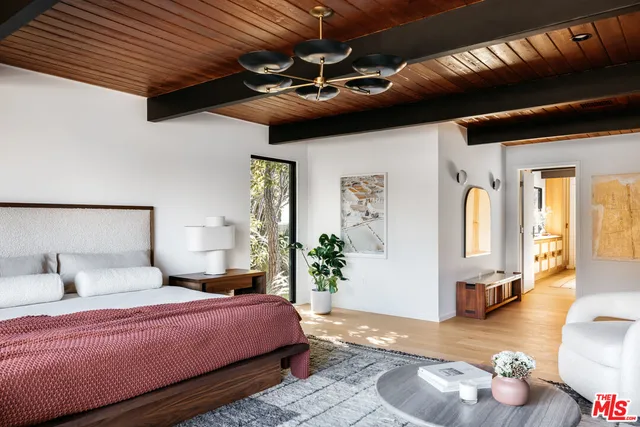 a view of hallway with wooden floor and furniture