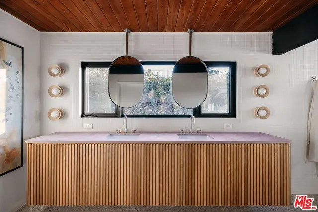 a bathroom with a double vanity sink and a large mirror