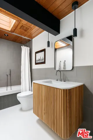 a bathroom with a sink and mirror