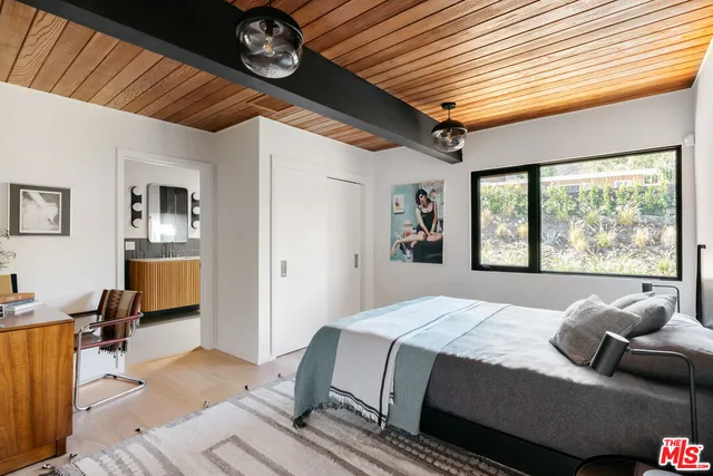 a bedroom with a large bed and a window