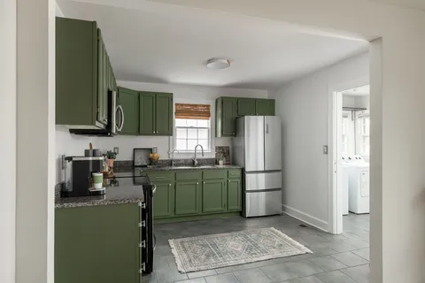 a kitchen with a refrigerator and a sink