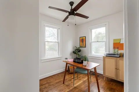 a dining room with furniture and window