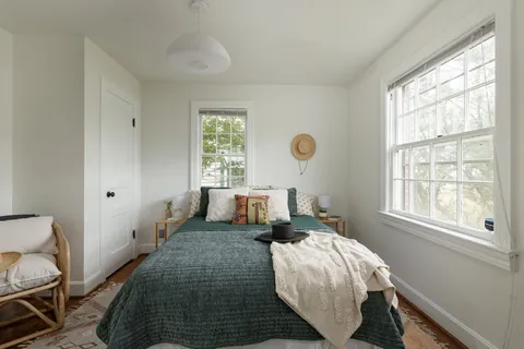 a bed room with a bed and a window