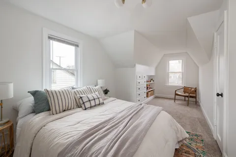 a bedroom with a bed and a chair