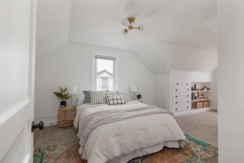 a bedroom with a bed and window