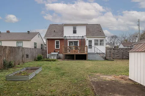 a view of a yard with a house and a large tree