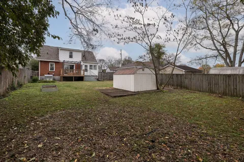 a front view of a house with a garden and plants