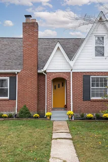 a front view of a house with a yard outdoor seating and barbeque oven