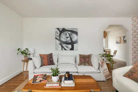 a living room with furniture and wooden floor