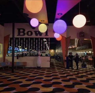a living room with furniture a flat screen tv and floor to ceiling window