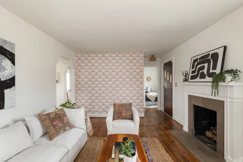 a living room with furniture and a fireplace