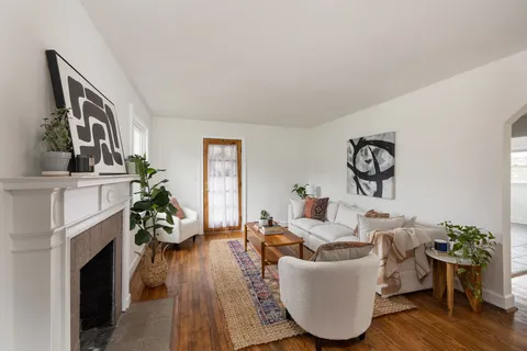 a living room with furniture and a fireplace