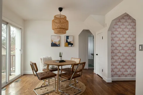 a dining room with furniture and wooden floor