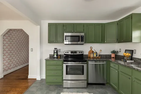 a kitchen with a sink a stove and microwave