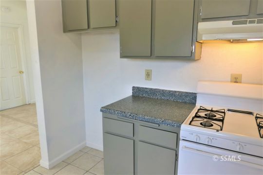 204 Sahara Drive Ridgecrest, CA 93555 - Photo 13 of 24 a kitchen with granite countertop cabinets stainless steel appliances and a counter top