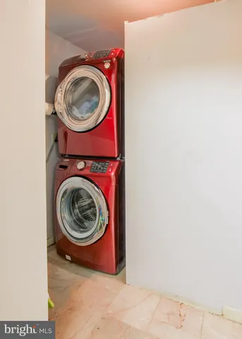 an empty room with windows and fireplace