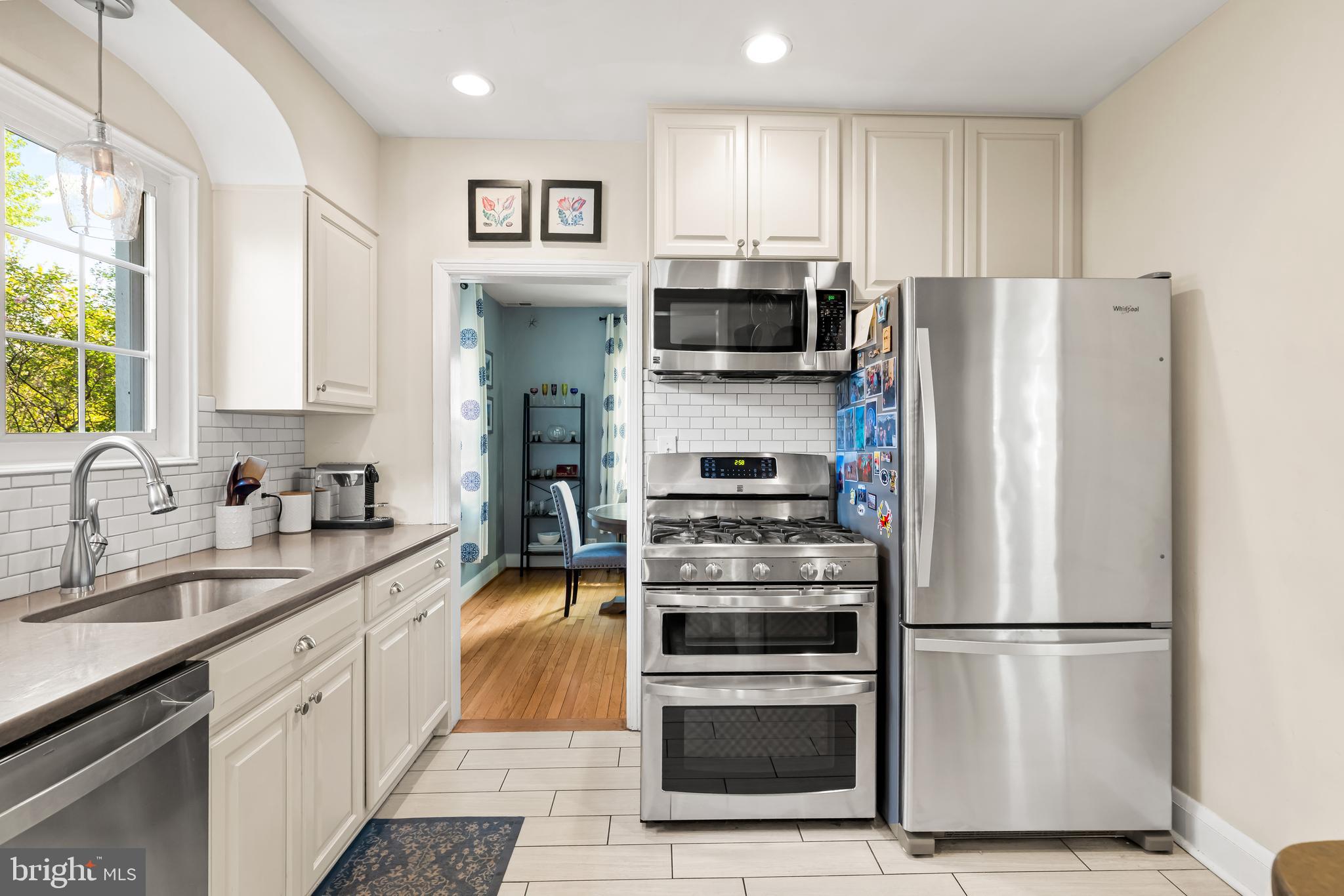 700 Regester Avenue Baltimore, MD 21212 - Photo 14 of 43 a kitchen with stainless steel appliances a refrigerator stove and microwave