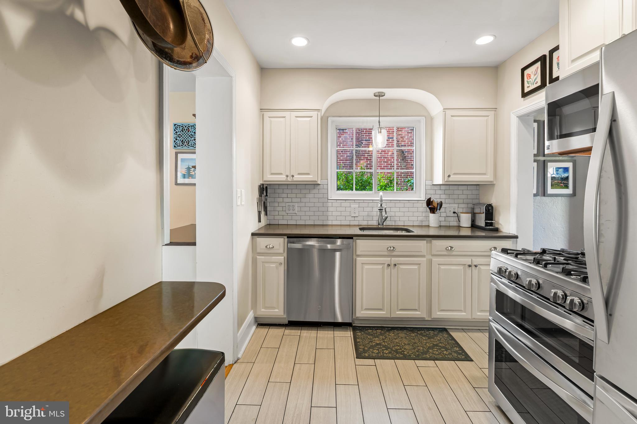 700 Regester Avenue Baltimore, MD 21212 - Photo 16 of 43 a kitchen with stainless steel appliances granite countertop a sink and a stove