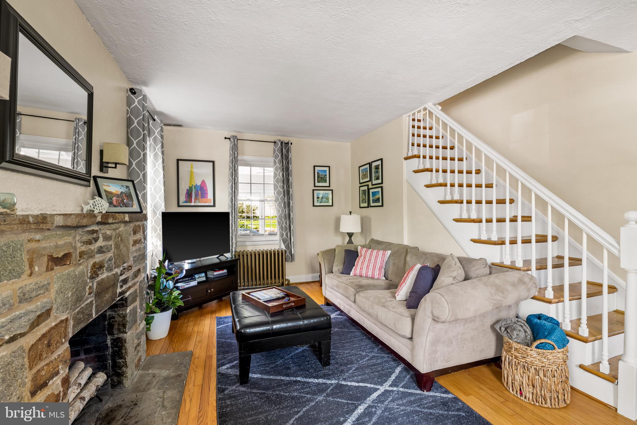700 Regester Avenue Baltimore, MD 21212 - Photo 23 of 43 a living room with furniture a flat screen tv and a fireplace