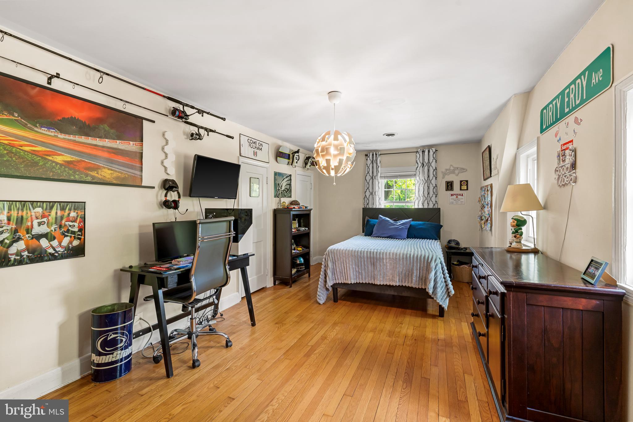 700 Regester Avenue Baltimore, MD 21212 - Photo 36 of 43 a spacious bedroom with a bed a flat screen tv and dresser