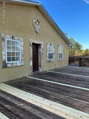 a view of a house with a door and wooden floor