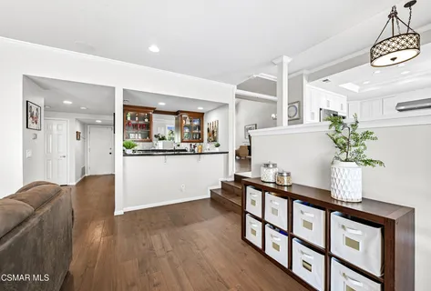 a living room with furniture and flowers