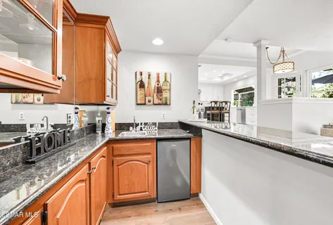 a kitchen with stainless steel appliances granite countertop sink stove and granite counter top