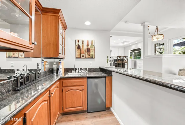 a kitchen with stainless steel appliances granite countertop sink stove and granite counter top