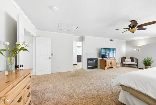 a spacious bedroom with a bed and ceiling fan