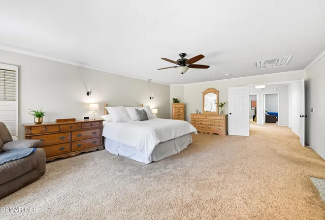 a spacious bedroom with a bed and ceiling fan