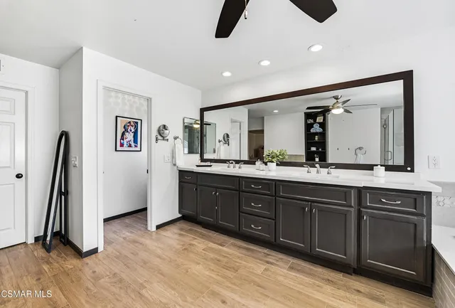 a spacious bathroom with a double vanity sink and a mirror