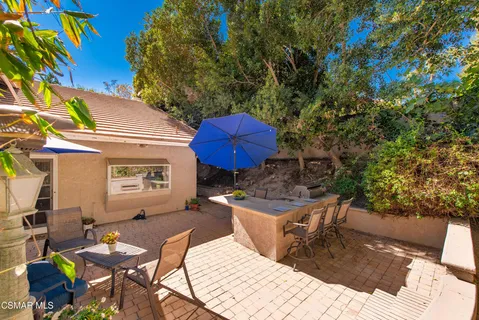 a view of a chairs and table in backyard
