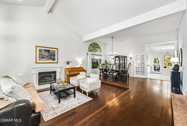 a living room with fireplace furniture and a wooden floor