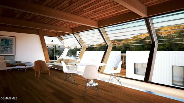 a view of living room with furniture and wooden floor